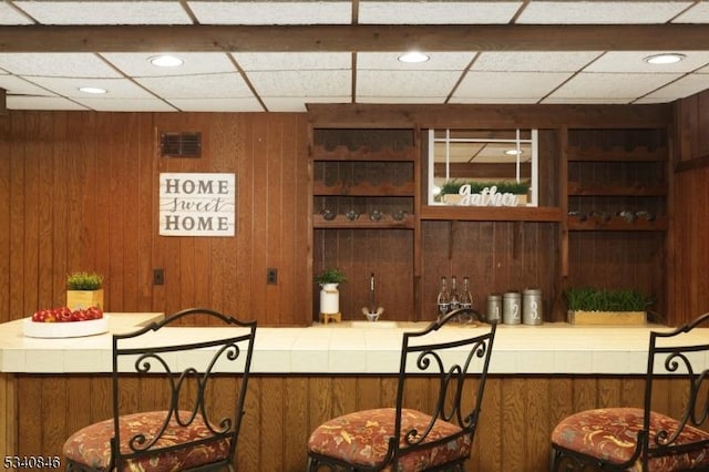 bar with visible vents and wood walls