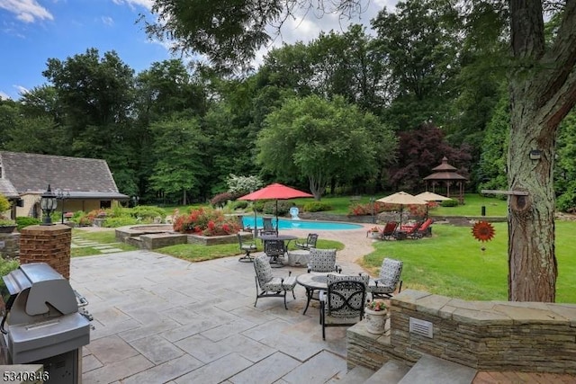 view of patio featuring an outdoor pool, a grill, and a gazebo