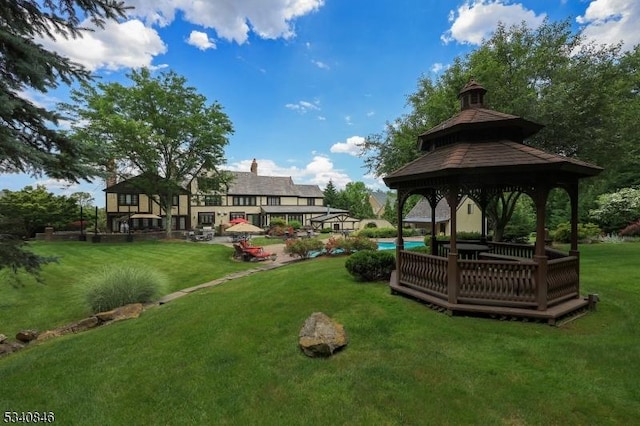 view of property's community featuring a swimming pool, a lawn, and a gazebo