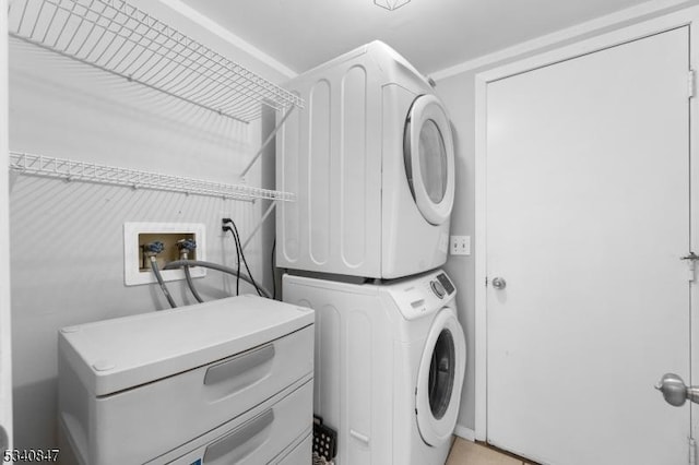 clothes washing area with laundry area and stacked washer / drying machine