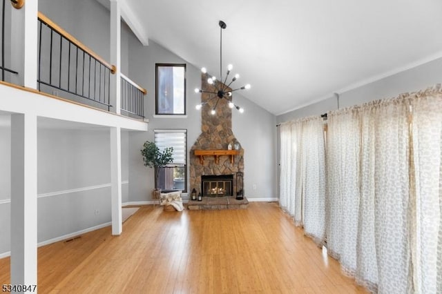 unfurnished living room with a stone fireplace, visible vents, baseboards, wood-type flooring, and an inviting chandelier