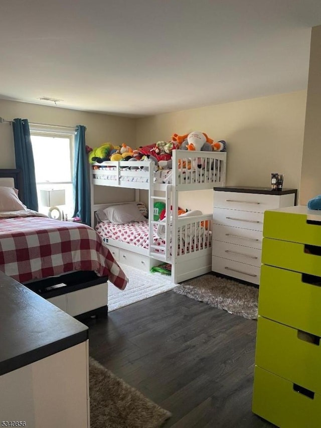 bedroom featuring dark wood finished floors