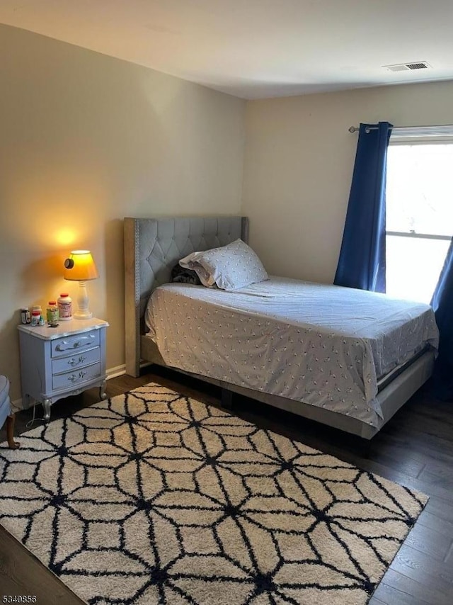 bedroom with wood-type flooring and visible vents