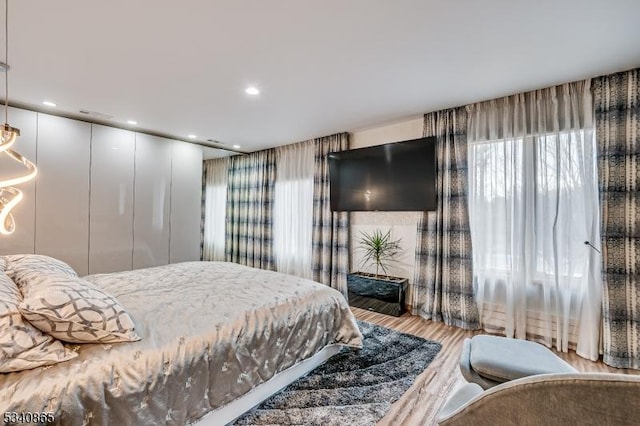 bedroom featuring wood finished floors and recessed lighting