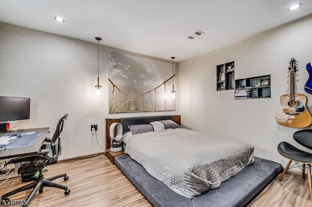 bedroom with recessed lighting, wood finished floors, visible vents, and baseboards