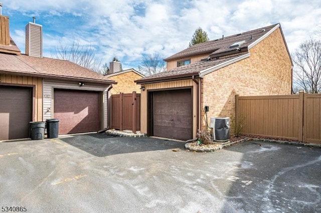 garage featuring cooling unit and fence