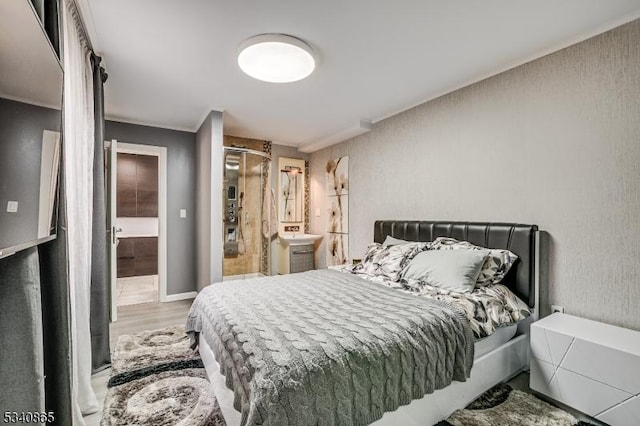 bedroom with wood finished floors and baseboards