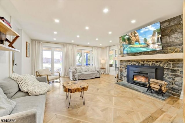 living room with a fireplace and recessed lighting