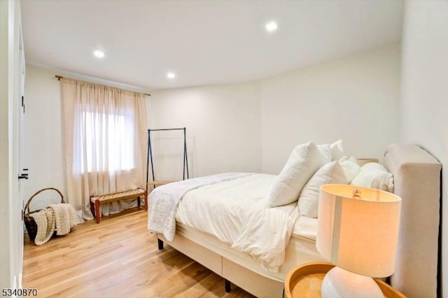 bedroom featuring wood finished floors and recessed lighting