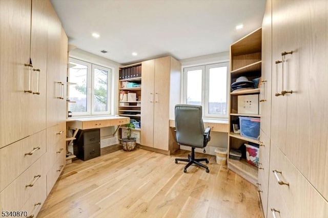 office with light wood finished floors and recessed lighting