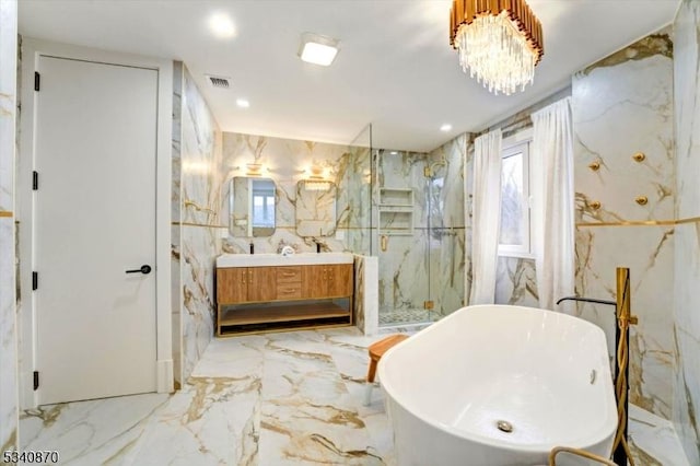 bathroom featuring a marble finish shower, visible vents, a freestanding tub, marble finish floor, and stone wall