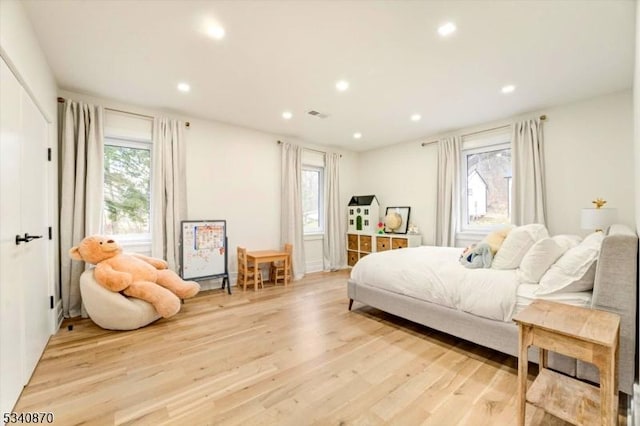 bedroom with light wood-style floors, visible vents, and recessed lighting