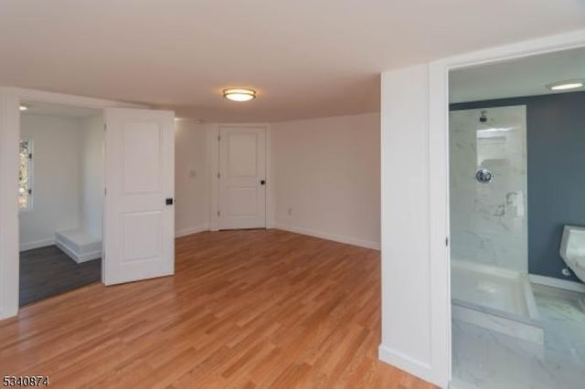 spare room with light wood-type flooring and baseboards