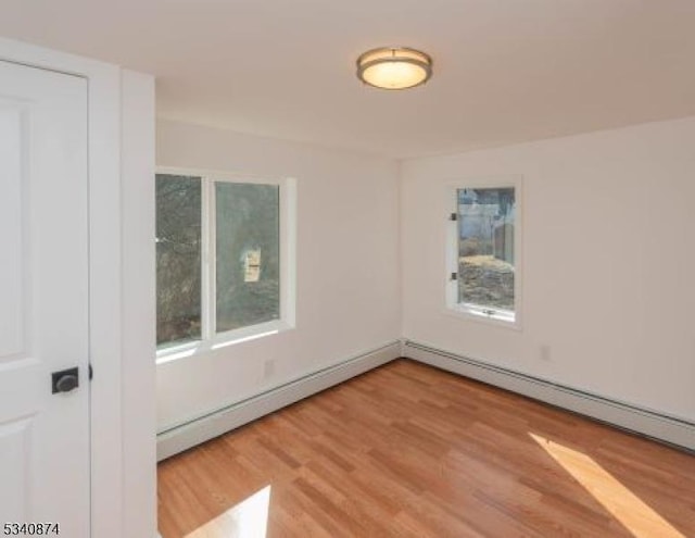 unfurnished room with light wood-type flooring and plenty of natural light