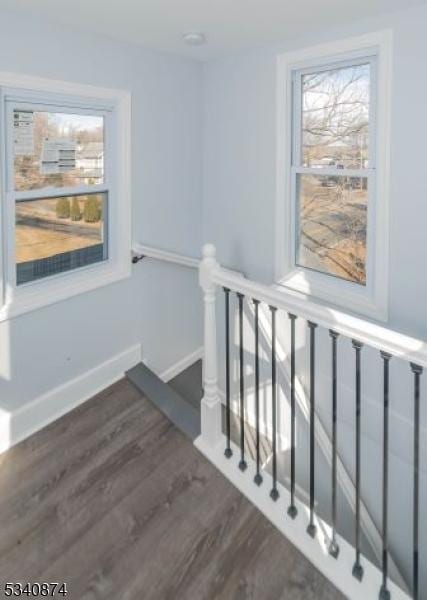 stairs featuring baseboards and wood finished floors