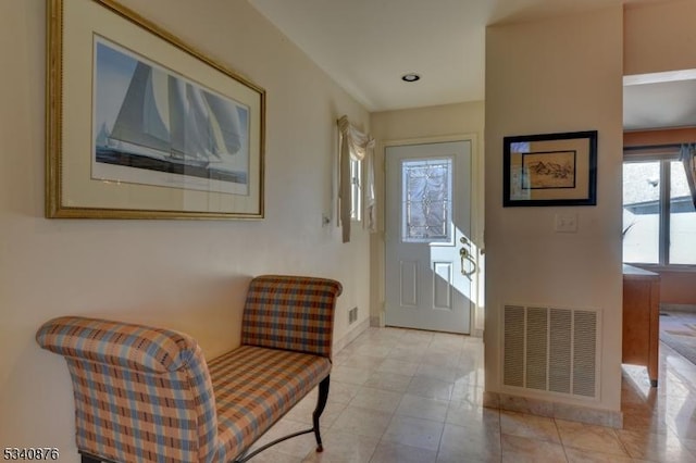 doorway featuring visible vents, baseboards, and tile patterned floors