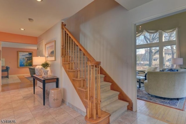 stairs featuring baseboards and recessed lighting