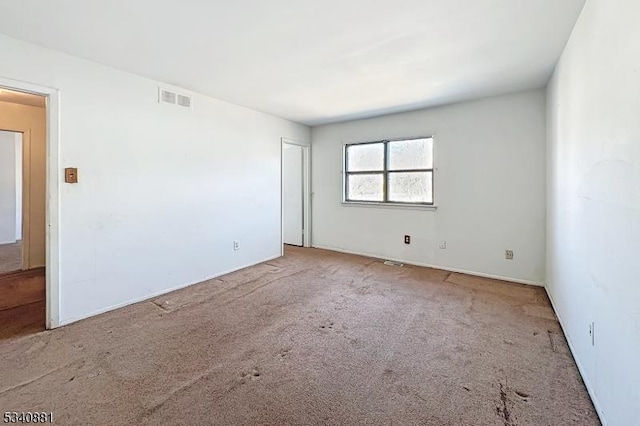 spare room with carpet floors and visible vents