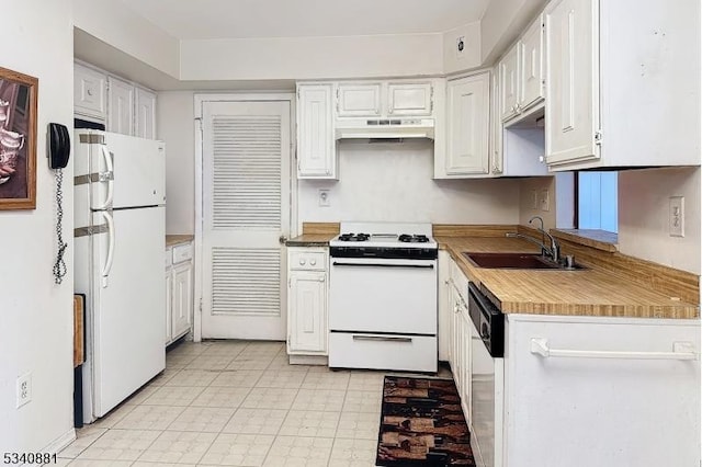 kitchen with white appliances, under cabinet range hood, white cabinets, and a sink