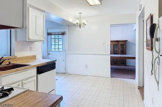 kitchen with a notable chandelier, white appliances, a sink, white cabinets, and light floors