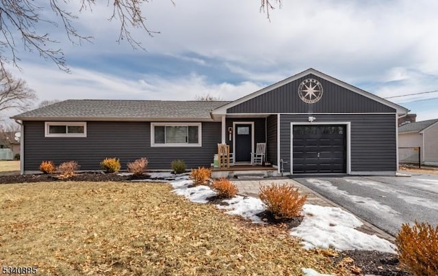 ranch-style house featuring driveway and an attached garage