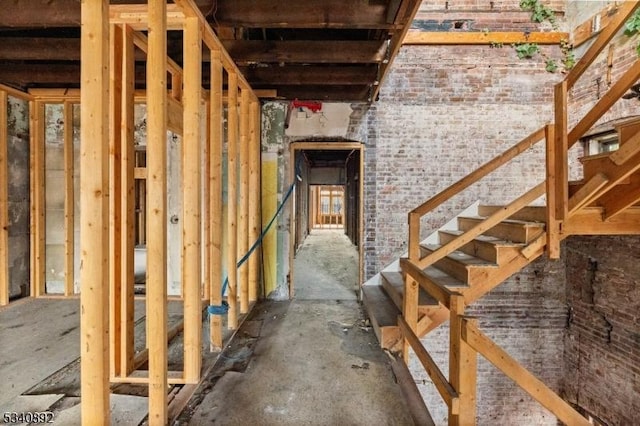 interior space with stairs and brick wall