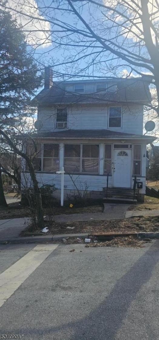 view of front of property with entry steps and a chimney