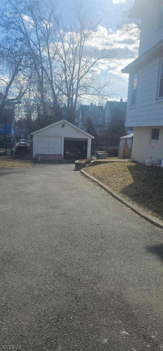 view of side of property with an outbuilding and a detached garage