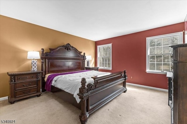 bedroom featuring light carpet and baseboards