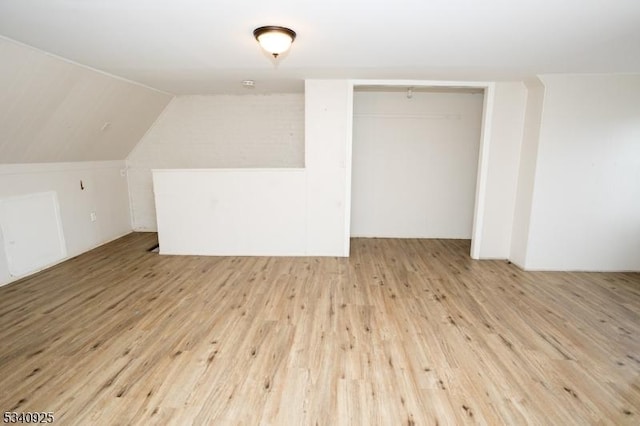 bonus room featuring lofted ceiling and wood finished floors