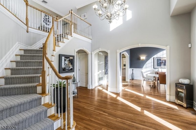35 Geiger Ln, Warren Twp, NJ 07059 - entrance foyer featuring arched walkways, wood finished floors, a chandelier, stairway, and ornamental molding