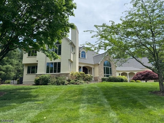 35 Geiger Ln, Warren Twp, NJ 07059 - view of front of home with stone siding, a front yard, and stucco siding