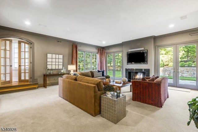 35 Geiger Ln, Warren Twp, NJ 07059 - living area with french doors, ornamental molding, light colored carpet, a warm lit fireplace, and recessed lighting
