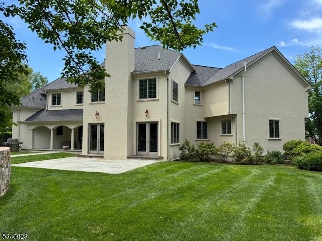 35 Geiger Ln, Warren Twp, NJ 07059 - rear view of property featuring french doors, a chimney, stucco siding, and a lawn