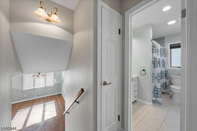 staircase featuring visible vents and baseboards