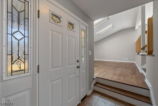 tiled foyer entrance featuring baseboards