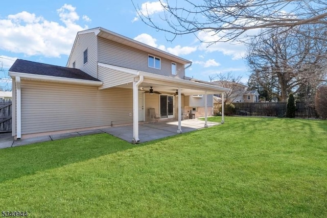 back of property featuring a ceiling fan, a patio area, a yard, and fence