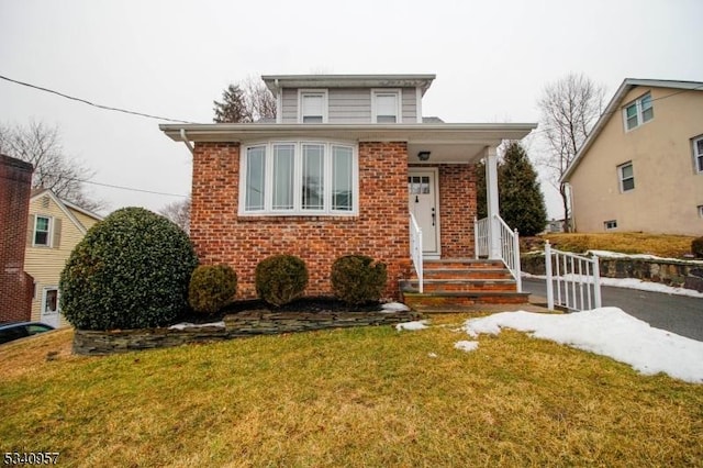 view of front of property with a front yard and brick siding