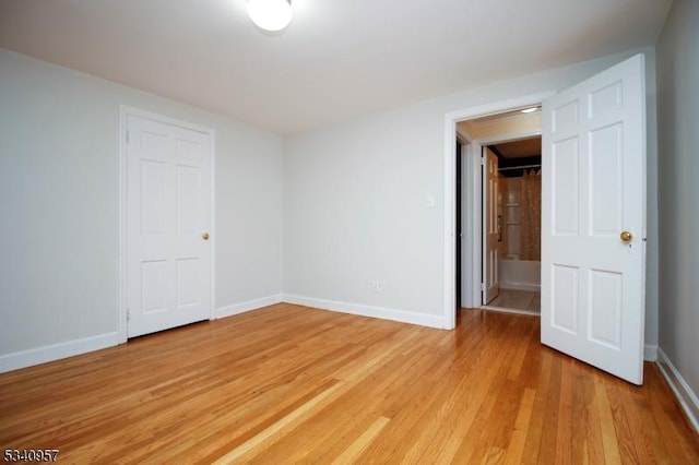 empty room featuring light wood-style floors and baseboards