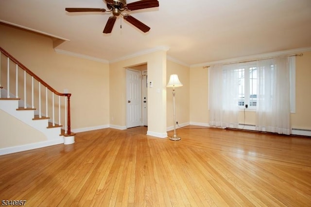 unfurnished living room featuring wood-type flooring, ornamental molding, and baseboards