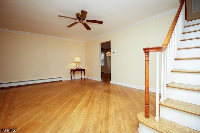 interior space featuring light wood finished floors, ceiling fan, stairway, and ornamental molding