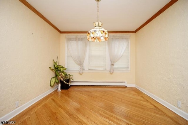 unfurnished dining area with a textured wall, baseboard heating, wood finished floors, and crown molding