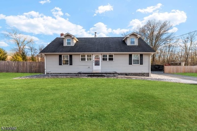 cape cod home featuring a shingled roof, fence, and a front lawn