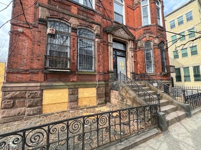 entrance to property featuring brick siding