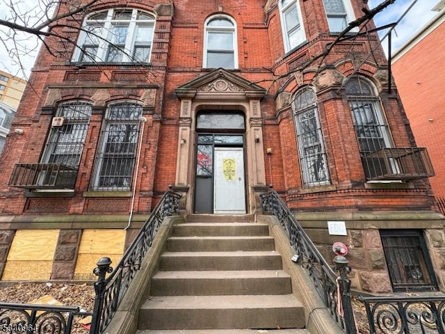 entrance to property featuring brick siding