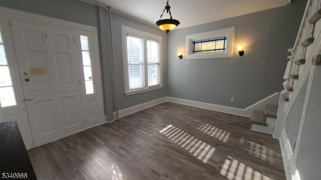 foyer entrance featuring stairway, baseboards, and dark wood finished floors