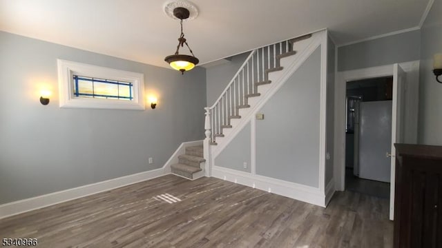 interior space with baseboards and wood finished floors