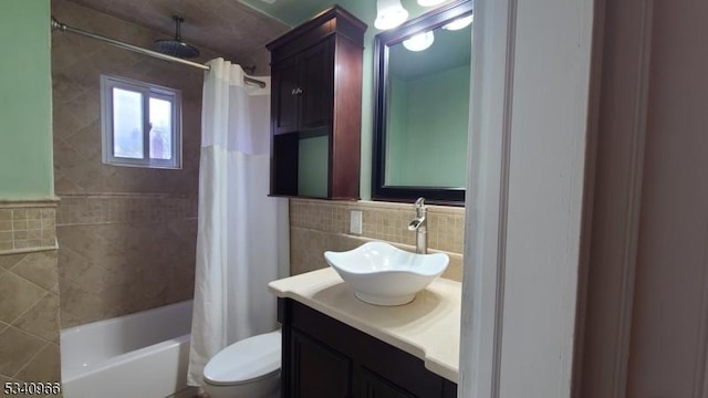 full bath featuring tile walls, a combined bath / shower with rainfall shower, vanity, and toilet