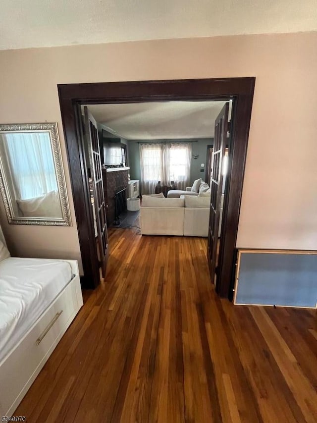 corridor featuring dark wood finished floors