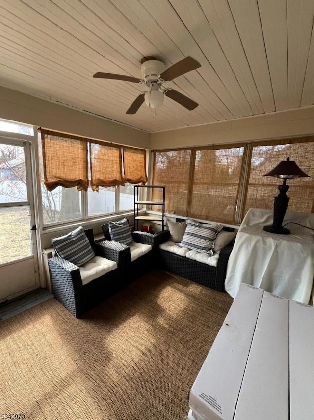 unfurnished sunroom with wooden ceiling and ceiling fan